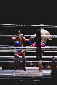 lumpinee boxing stadium two male fighters in ring while there is a sign forbidding women to touch the ring muay thai