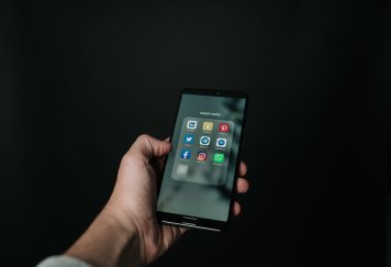photo of hand holding a black smartphone