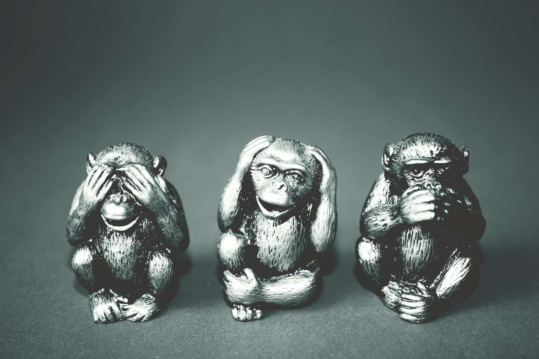grayscale photography of three wise monkey figurines