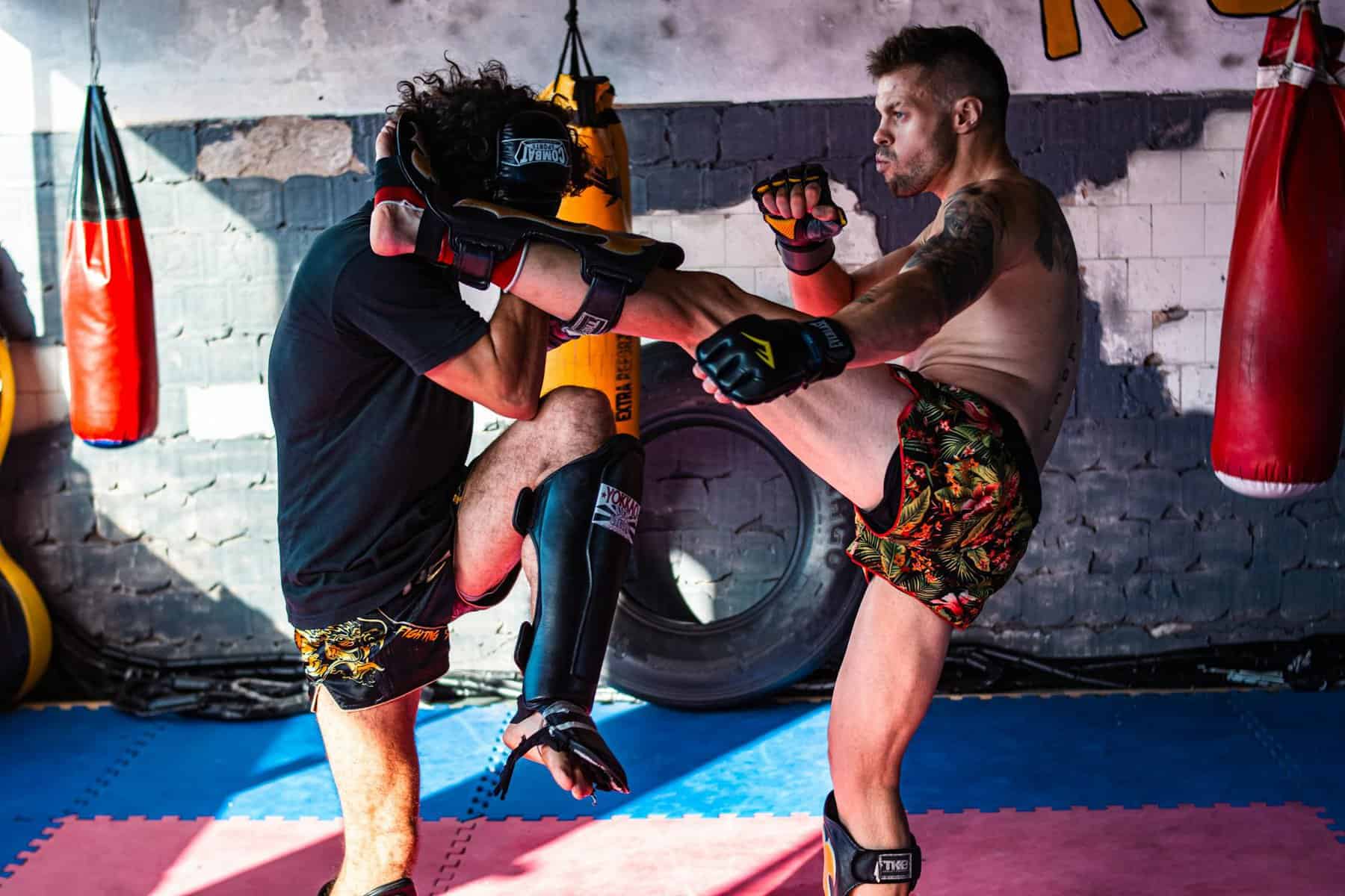 two kickboxers sparring in a gym