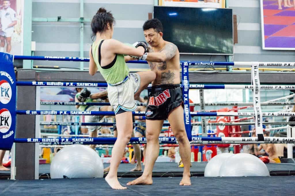 woman and man knee sparring