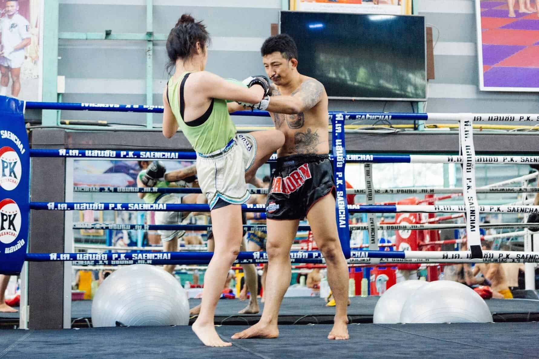 woman and man knee sparring