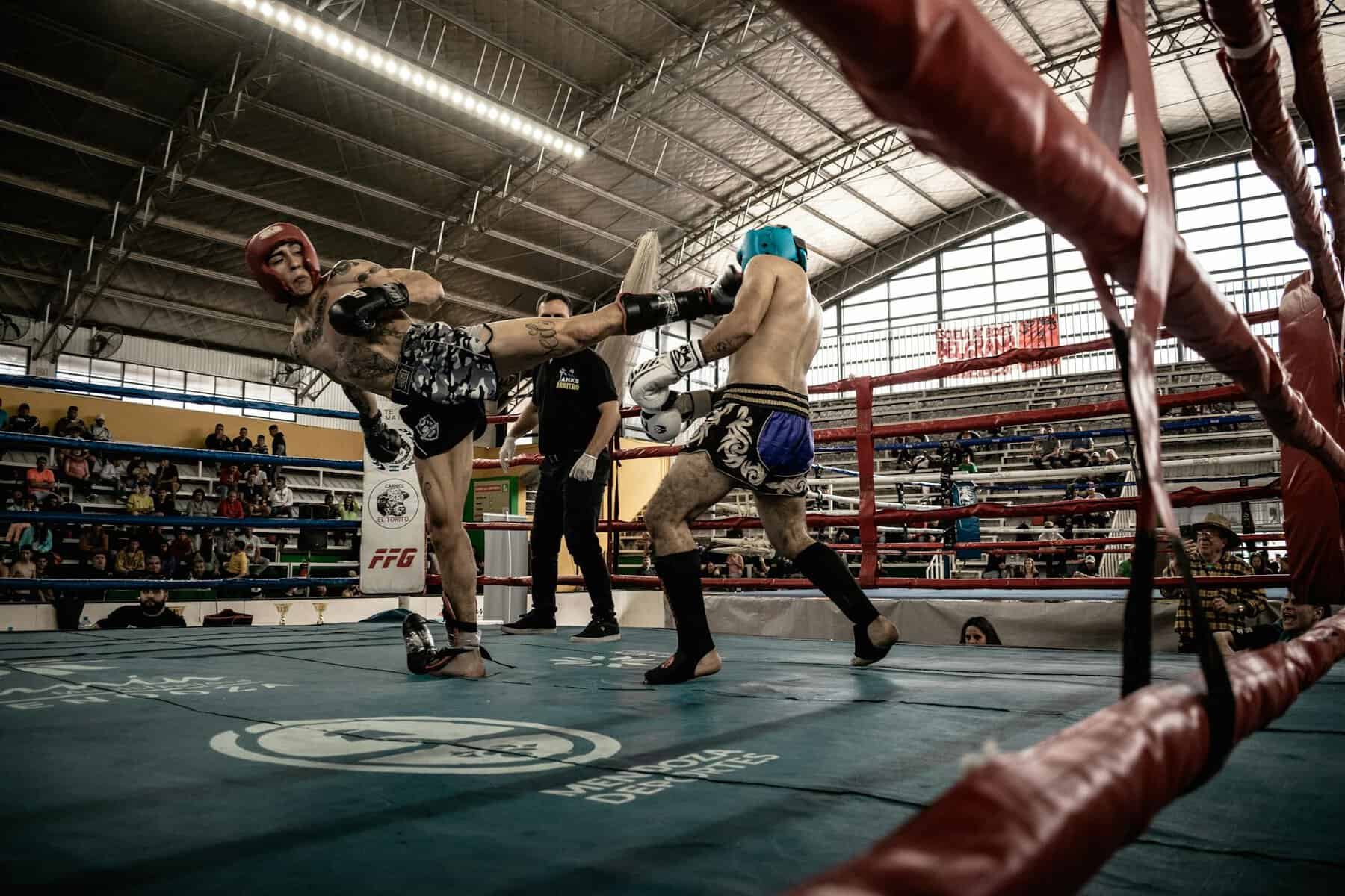men kickboxing in ring