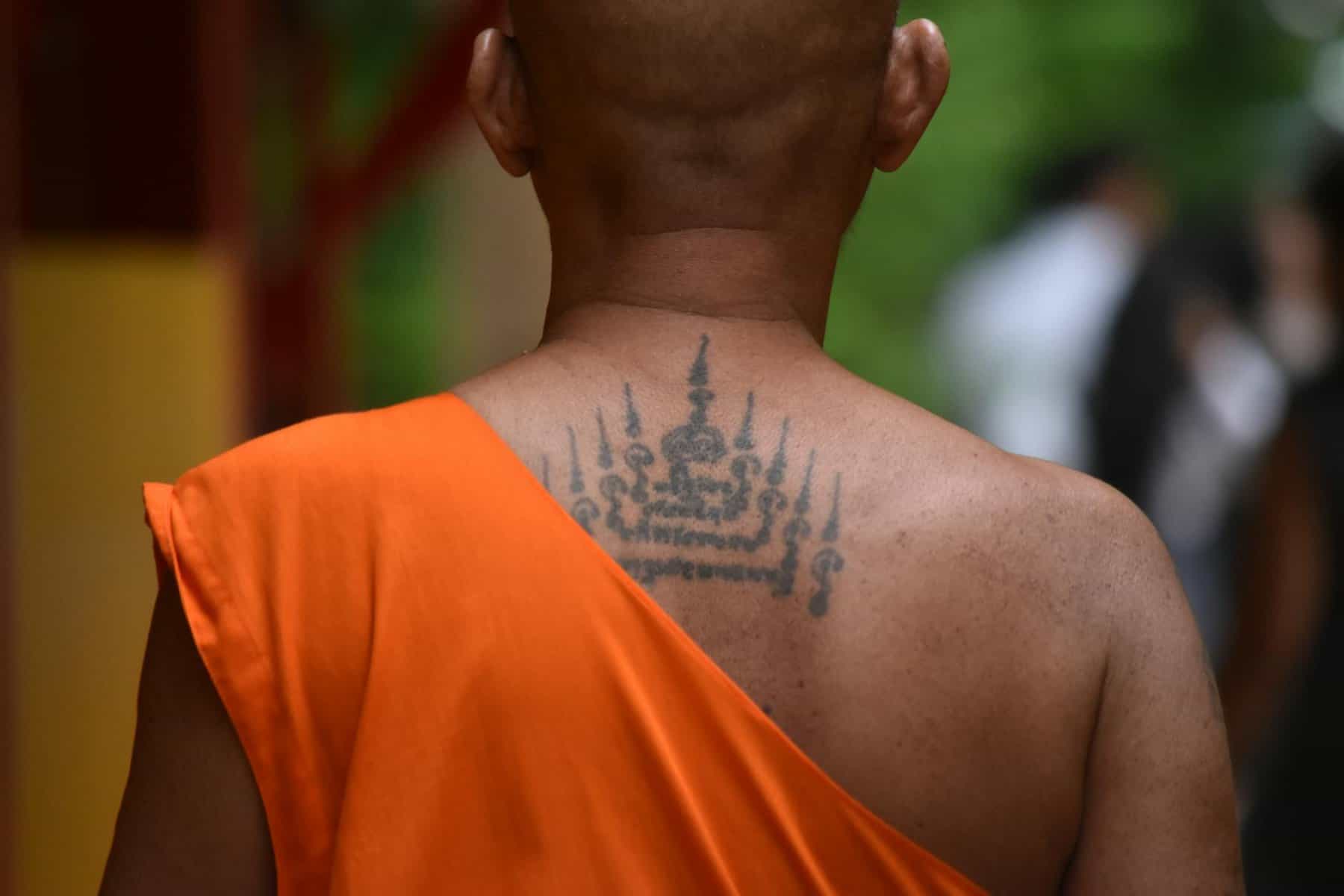 man with black tattoo on his back