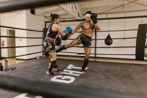 man and woman during a kickboxing workout