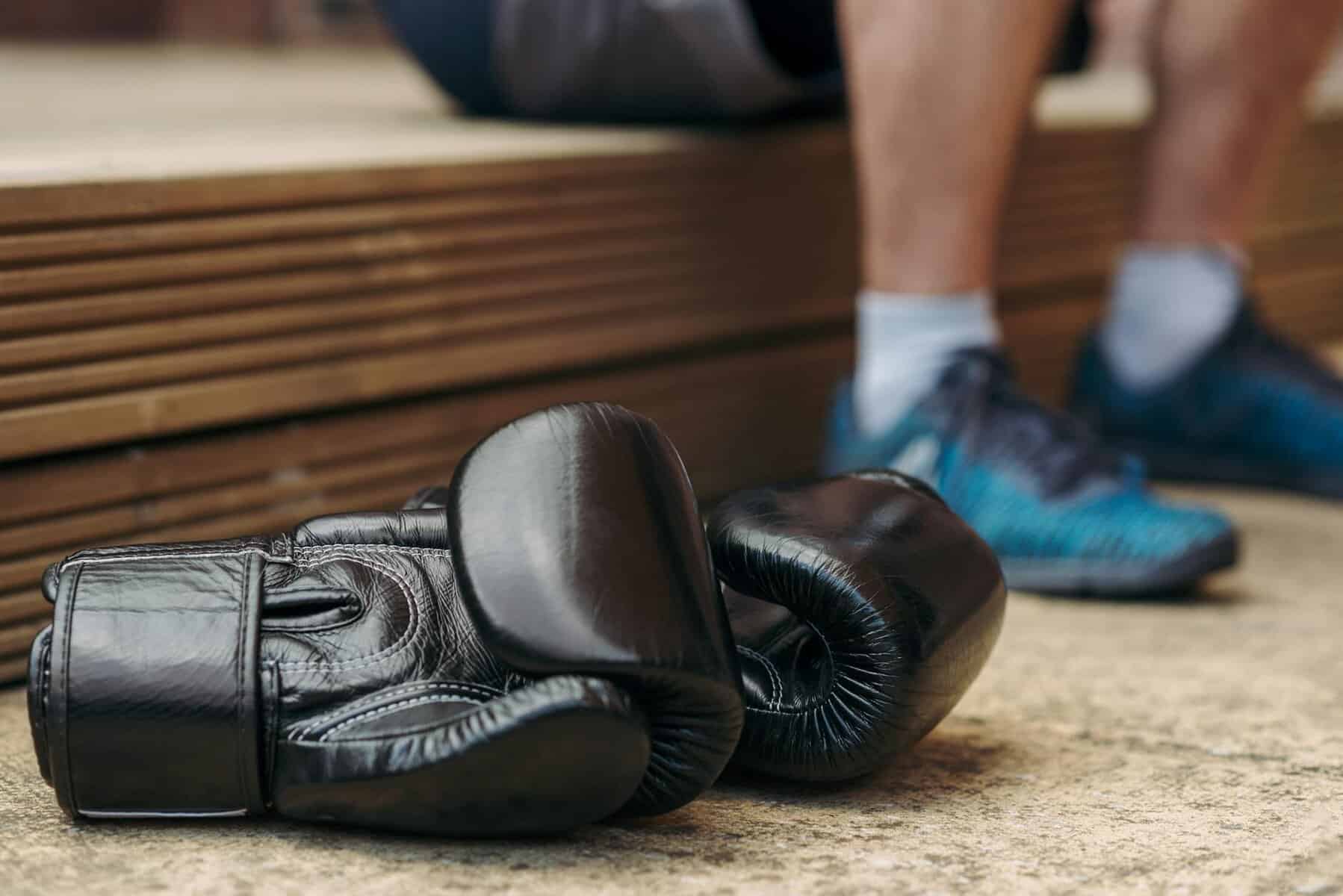 black leather boxing gloves on the floor