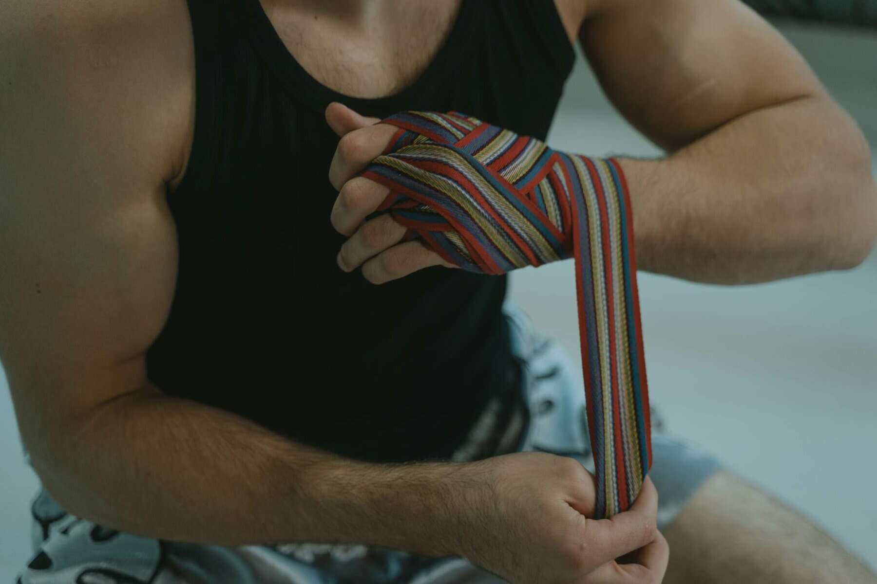 unrecognizable man wrapping his hand