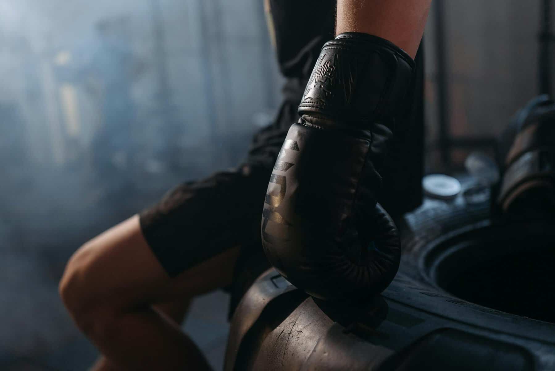 a boxer wearing black boxing gloves